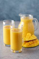 Mango smoothie in glasses. Fresh breakfast, detox drink