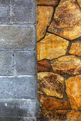 Stone wall, combined with a cement wall. Figure gray modern design style decorative uneven cracking real marble stone surface of the wall with cement