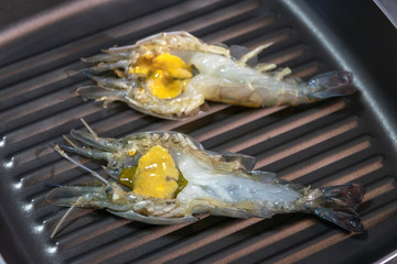 Grilled river prawn cooking on pan.
