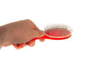 hand holds a comb on an isolated white background.