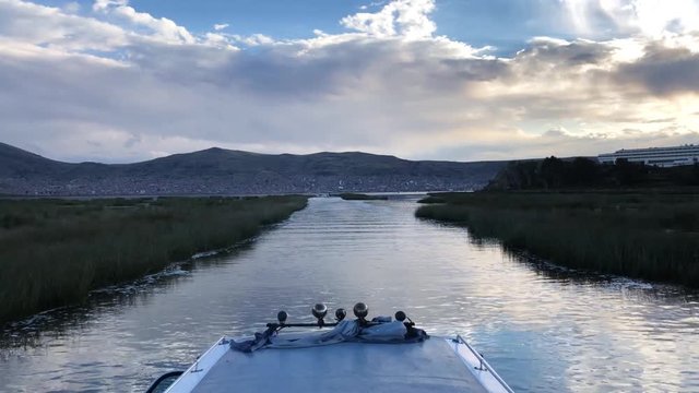 Awesome view of the city of Puno in Lake Titicaca, Per&uacute;. Shot from a boat while returning to Puno after visiting the uros islands. Barca volviendo de las Islas flotantes de los Uros.