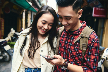 Fototapeta na wymiar Vietnamese couple using mobile phone as a navigation tool