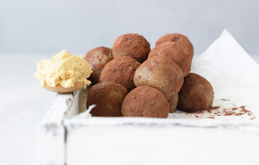 Raw vegan healthy dessert or energy balls with peanut butter, wooden tray. Selective focus. 