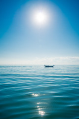 Boat sailing in the sun through the Arabigo Sea in the direction of Masirah Island, Oman