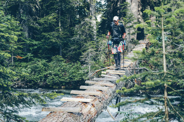 Man on the bridge in the wild.