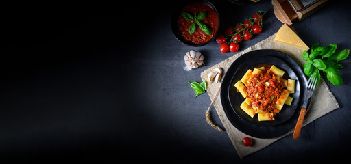 Rigatoni pasta with Bolognese sauce and fresh basil