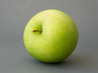 Closeup green apple on grey background, fruit for healthy diet concept