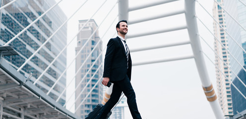 Business caucasian men dragging luggage to go to the airport. Coronavirus travel restrictions and...