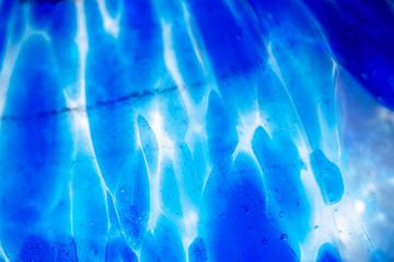 Dark background with blur blue light circles with waves. Abstract defocused pattern