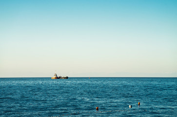 Tugboat is pushing another vessel on the sea