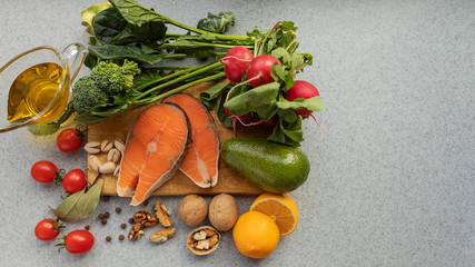 Healthy food with low carb content, on a gray table. The concept of a ketogenic diet, health and youth. Ingredients of the keto diet, protein food. The view from the top. Space for copying.