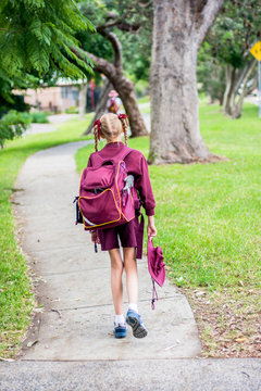 A girl walking to school alone. NSW students to transition back to the classrooms in Term 2 as the Government continues to deal with Coronavirus