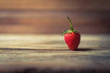 closeup of strawberry fruit on grunge wooden