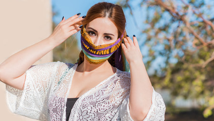 Young woman in fashionable homemade mask, scarf on her face, stop virus, save yourself, modern lifestyle