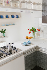 
Two cups of coffee, croissants, newspaper, a bouquet of red tulips on the table. The concept of morning and breakfast.