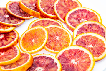 Sicilian sliced ​​orange on a white plate on a white background. Sliced ripe Sicilian oranges...