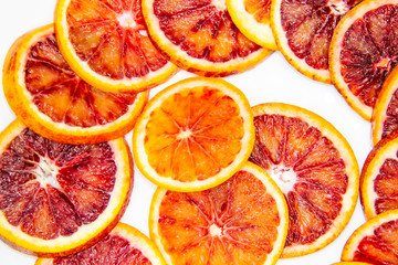 Sicilian sliced ​​orange on a white plate on a white background. Sliced ripe Sicilian oranges...