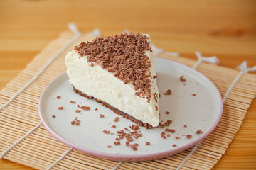 chocolate cheesecake on white plate on  wooden table