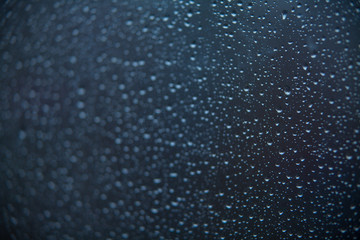 beautiful pattern with raindrops on glass in autumn