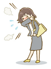 咳マナーを守って咳をするスーツ女性