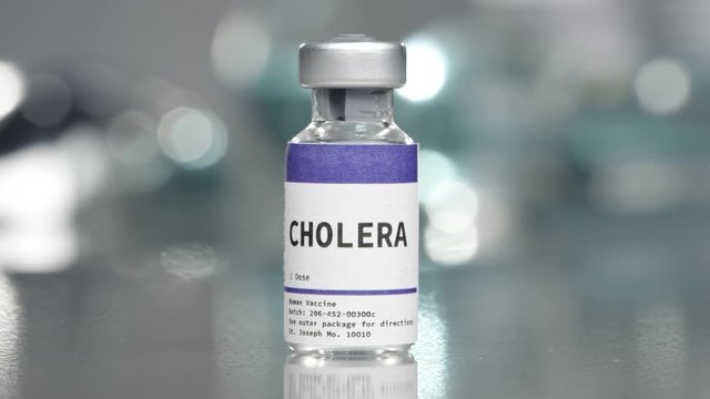 Cholera vaccine vial in medial lab slowly rotating.