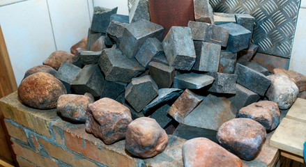 Hot stones in the sauna bath - Finnish sauna. Stones in the sauna heater close-up.