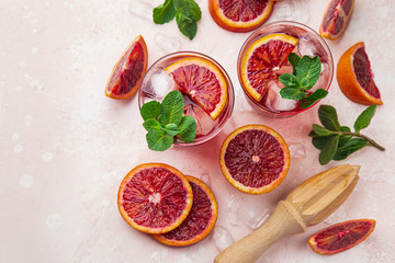 red blood orange cocktail with ice and fresh mint