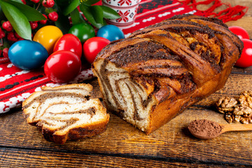 Traditional Romanian Easter table with cozonac and pasca meaning Sweetbread and Matzo an unleavened flatbread that is part of Jewish cuisine and forms an integral element of the Passover. Happy Easter