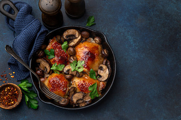 roasted  chicken thighs with mushrooms on cast iron  pan