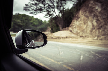 car mirror and photographer take a photo of inside road