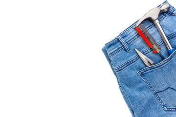 Jeans, screwdriver, hammer and pliers on white background. Jeans texture, Blue denim jeans with tools. Copy space concept