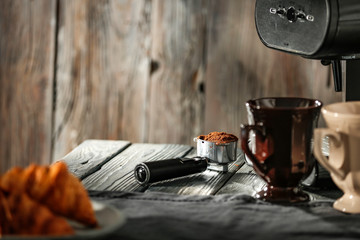 Morning coffee on a wooden table in the light of the sun