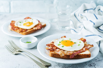 Fried egg fried bacon sandwiches on a light background