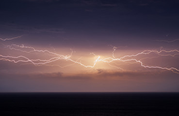 Yellow horizontal lightning across the whole sky over the Black sea in Crimea