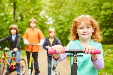 Fototapeta na wymiar Group of kids on a bike ride in the park