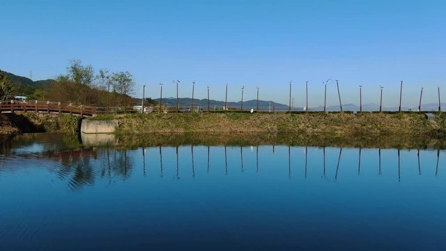 the blue sky reflected in the tranquil reservoir.