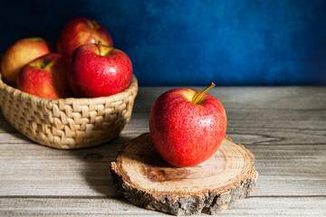 Delicious red apple on wood slice