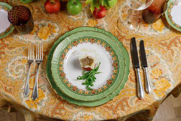 fish tartare with arugula, cheese and truffles on a green plates. top view