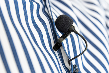 Black Clip-On Microphone on a blue striped shirt