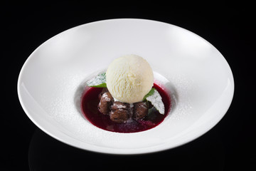 Cupcake with ice cream, raspberry syrup with Basil, on a white plate