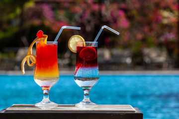 Two cocktails by the pool. Selective focus