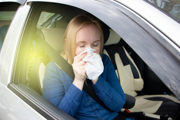Nausea during a car trip. A blonde woman suffers from kinetosis. The concept of motion sickness in...
