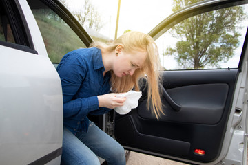 Nausea during a car trip. A blonde woman suffers from kinetosis. The concept of motion sickness in...