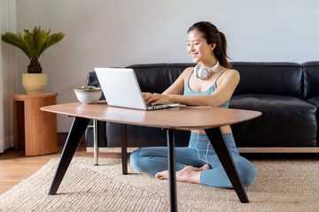 A young Asian woman in a sports office at home