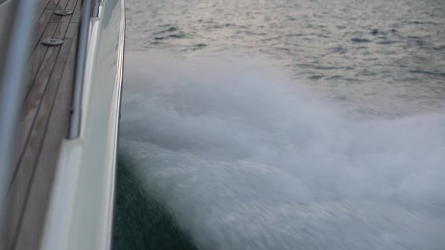 flying splashes of waves from the starboard side of a motor boat in slow motion