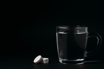 Glass with water on a black background. Cup of water.