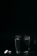 Glass with water on a black background. Cup of water.