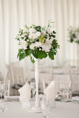 Wedding centerpieces. White flower arrangements for table. 
