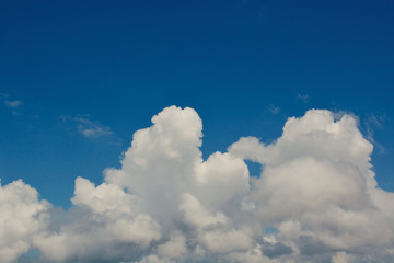 Fototapeta na wymiar Fluffy White Clouds with Clear Blue Sky