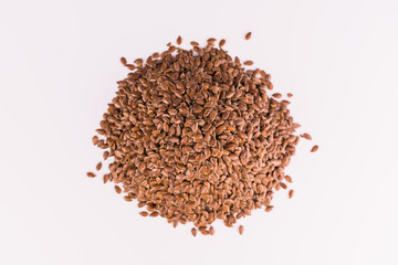 A handful of flax seeds on a white background. Top view.